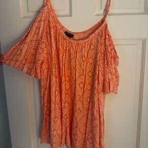 Orange and white patterned Torrid cold shoulder top with sleeves.